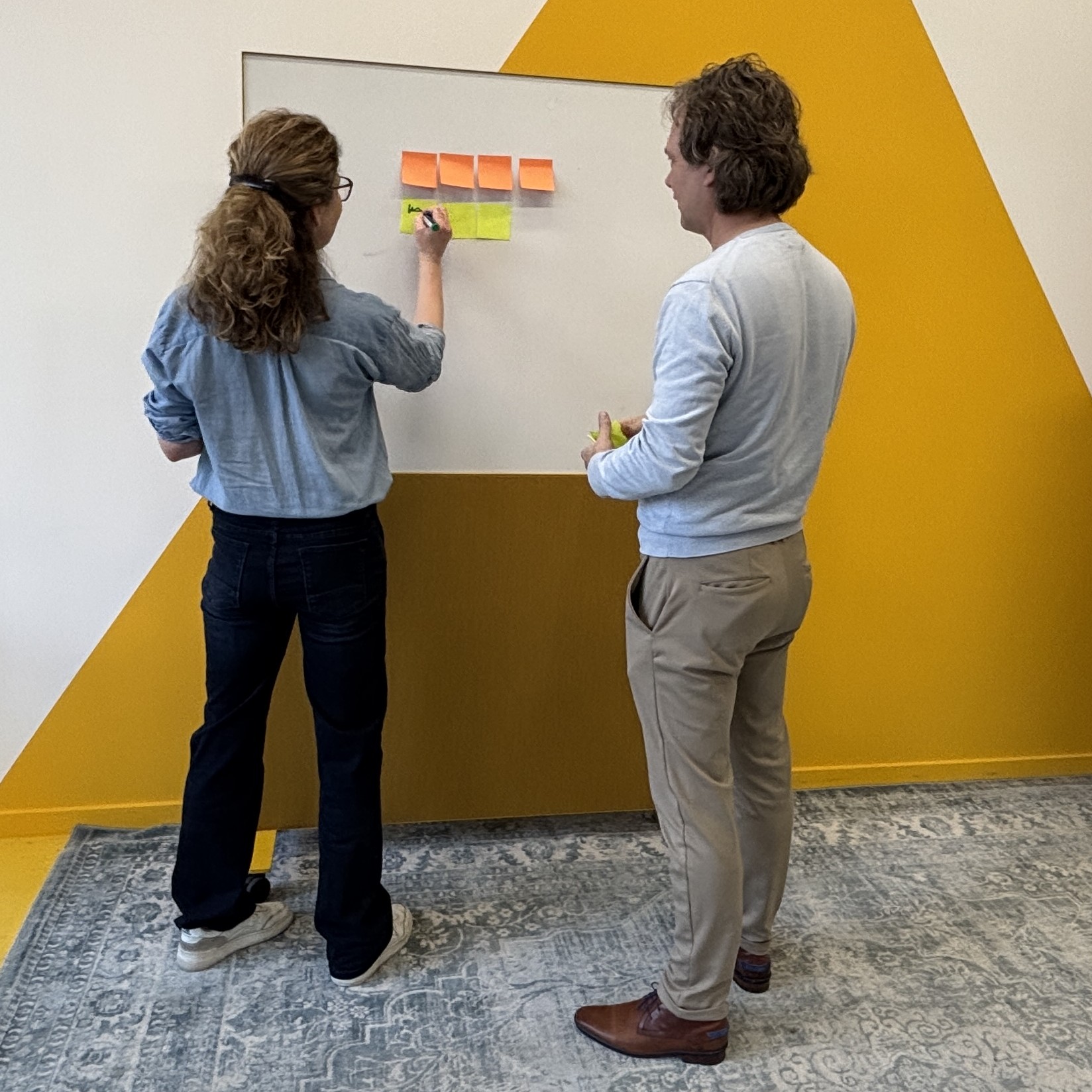 Petra Macova guiding a coaching workshop at a whiteboard